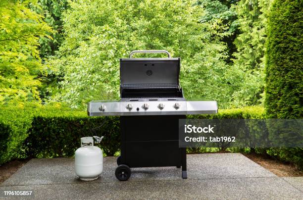 Large Outdoor Bbq Cooker With Lid In Open Position On Home Concrete Patio Stock Photo - Download Image Now