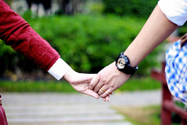 istock Couple hold hands with blur background.Love Concept 1196113288