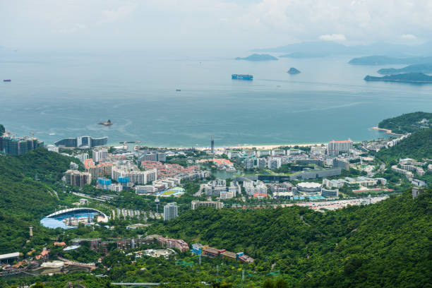 Buildings and sea at the costline of Shenzhen, view from the valley at Shenzhen Overseas Chinese Town East (OCT East) in Guangdong, China stock photo