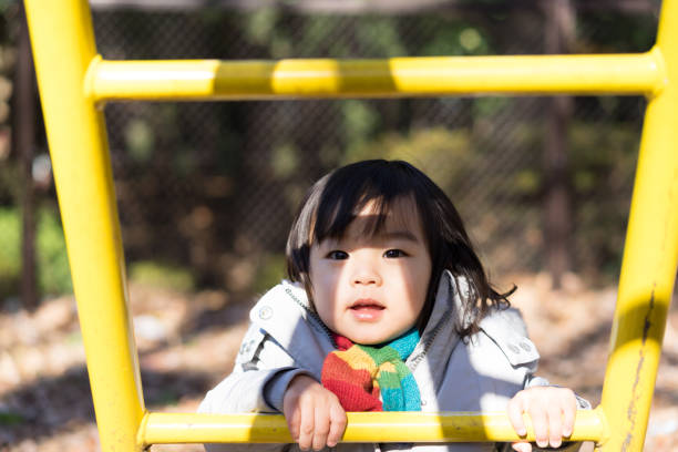 istock Children playing with play equipment (natural expressions and light) 1196117672
