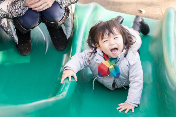 istock Children playing with play equipment (girls, slides, facial expressions) 1196117715