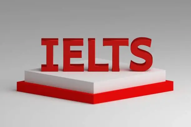 Photo of Red word letters IELTS on white pedestal