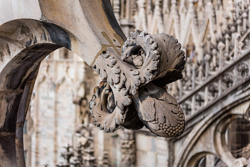 Beautiful architectural details with statues on the top of  building of the Milan Cathedral (Duomo di Milano), the cathedral church of Milan, Lombardy, Italy. Dedicated to the Nativity of St Mary.