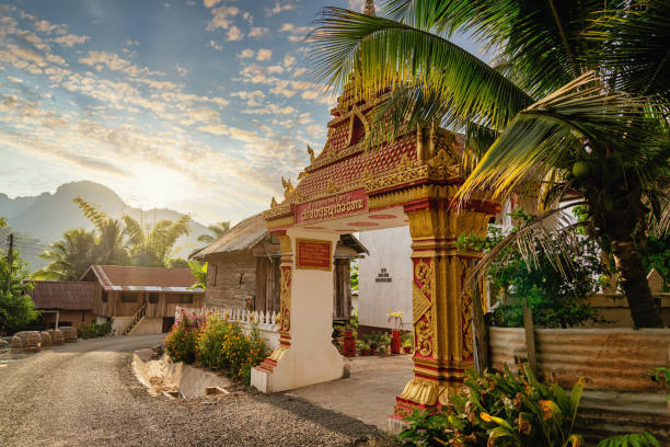 Sunset twilight over the colorful ornamental entrance gate to Wat Pak Ou in the city of Pak Pu at the Mekong River close to Luang Prabang, Laos, Southeast Asia