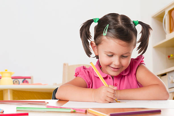 istock Smiling child drawing with a pencil and paper 119612667