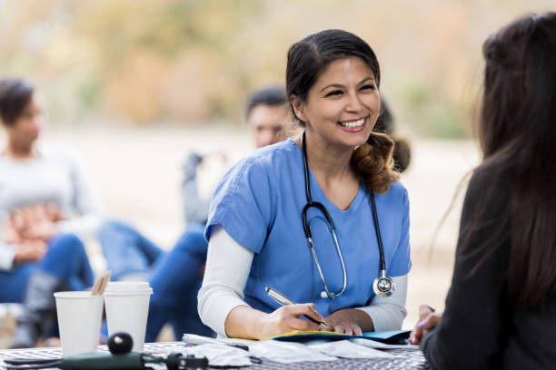 istock Attentive nurse talks with female patient 1196128925