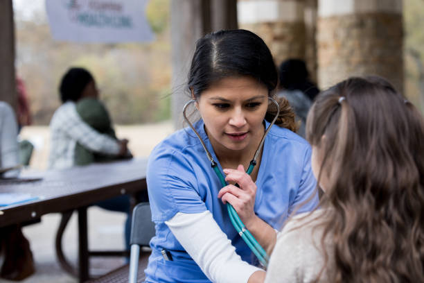istock Serious nurse checks patient's heartbeat 1196128949