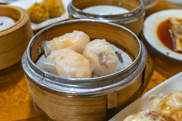 istock Steamed stuffed shrimp dumpling in dimsum bamboo steamer box 1196137219