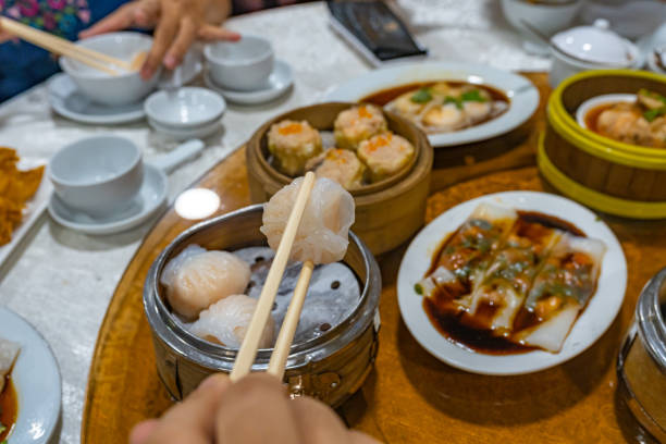 istock People using chopsticks and having Hong Kong dimsum in restaurant 1196139789
