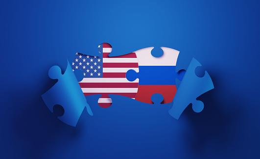 Jigsaw puzzle pieces textured with American and Russian flags. Horizontal composition with copy space and selective focus. Solution concept