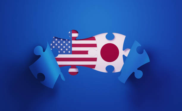 istock Jigsaw Puzzle Pieces Textured With American and Japanese Flags 1196144163