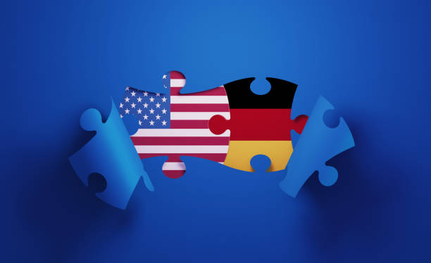 istock Jigsaw Puzzle Pieces Textured With American and German Flags 1196144214