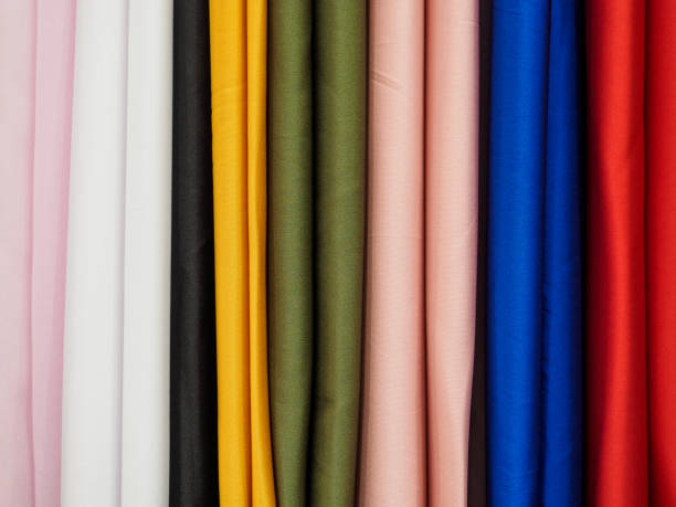 istock Multicolored samples of knitted fabric in an upright position. Woven texture and background 1196147005