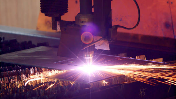 Laser cutting machine Industrial laser cutting with high precision processing manufacture technology of flat sheet metal steel material with sparks sandwich panel photos stock pictures, royalty-free photos & images