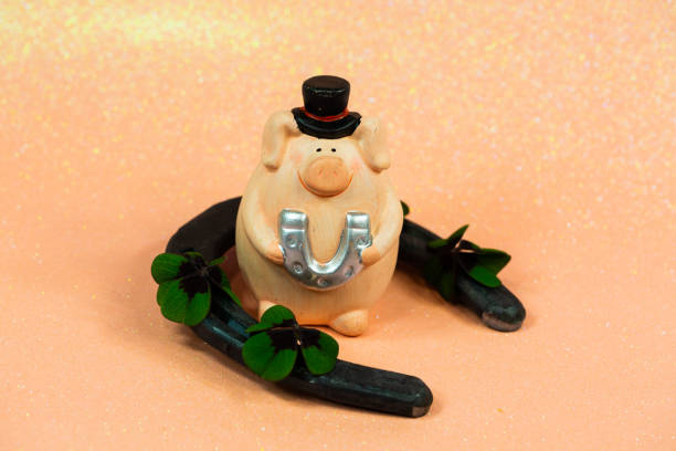 istock Lucky pig on pink background with shamrocks; horseshoes 1196157178