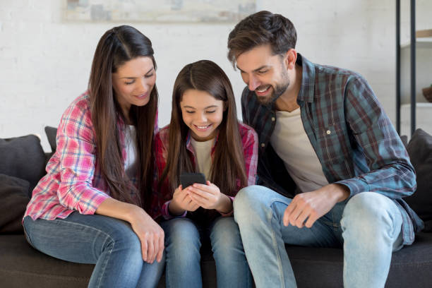 istock Family and kid having fun with smartphone 1196159093