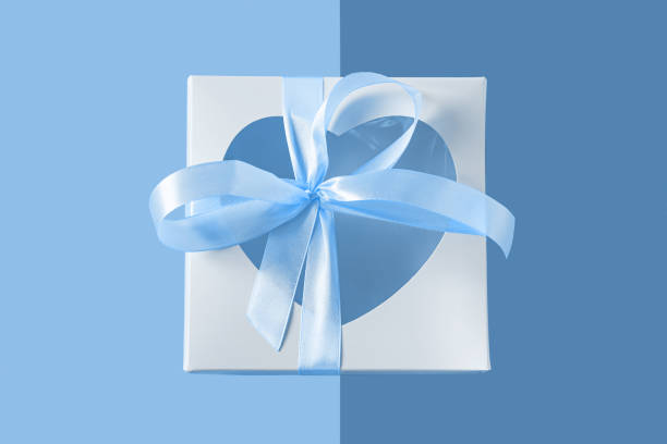 istock White gift box with heartshaped window and card tag on pastel blue background flatlay, creative minimal concept. 1196159458