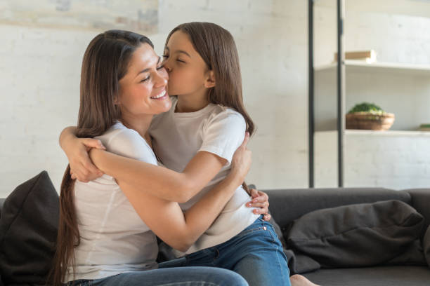 istock Daughter kiss happy mom 1196160949