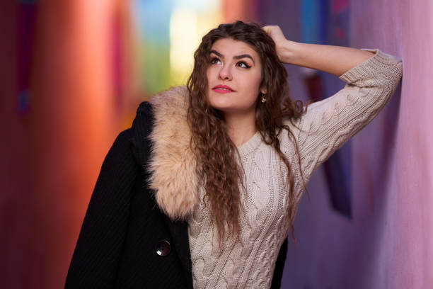 A young woman on a narrow street in an old town
