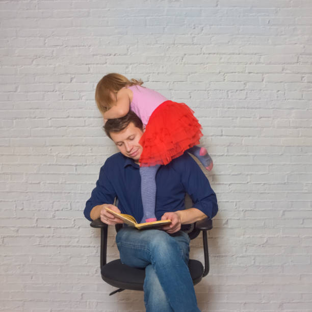istock father and daughter against a white brick wall 1196162223