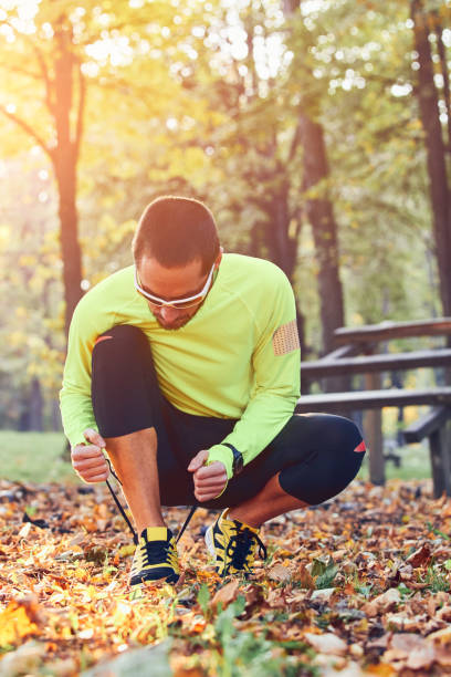 istock Preparing for jogging in autumn colored park. 1196163185