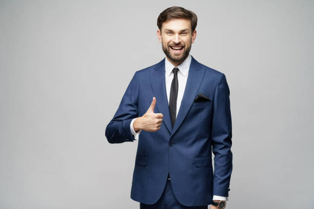 istock young business man going thumb up on grey background 1196163402