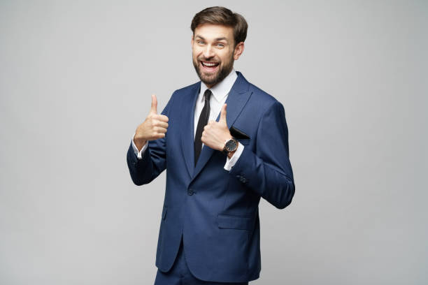 istock young business man going thumb up on grey background 1196163419