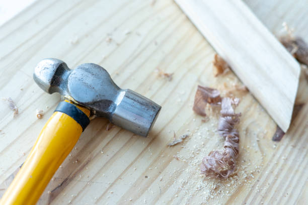 istock Yellow iron hammer and wood chips on the woodworking table. 1196163617