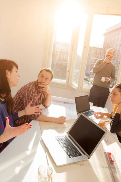istock Team made of young architects in the sunny office. 1196163732