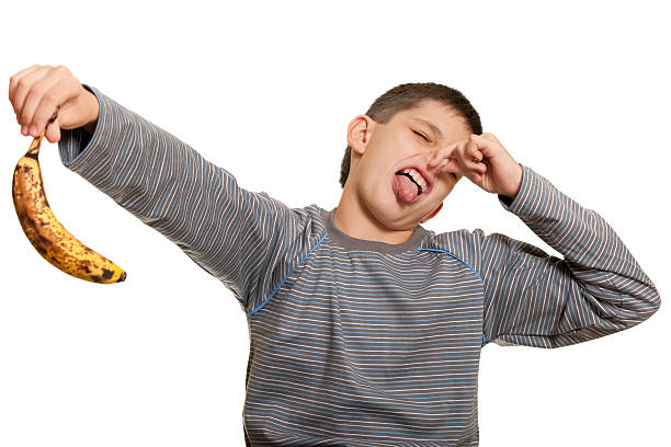 istock Dissatisfied kid holding an ugly banana 119616649