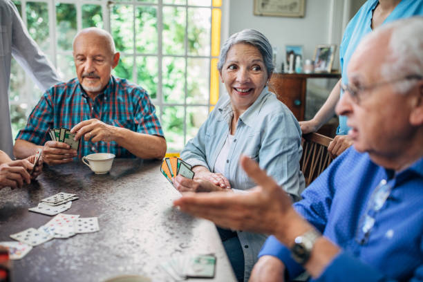 istock Group of seniors playing cards together 1196167571