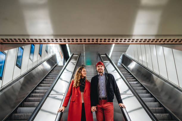 istock Couple in love on subway escalator 1196167608