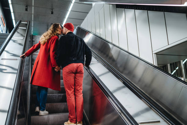 istock Couple in love on subway escalator 1196167619