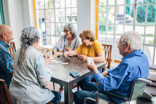 istock Group of seniors playing cards together 1196167695