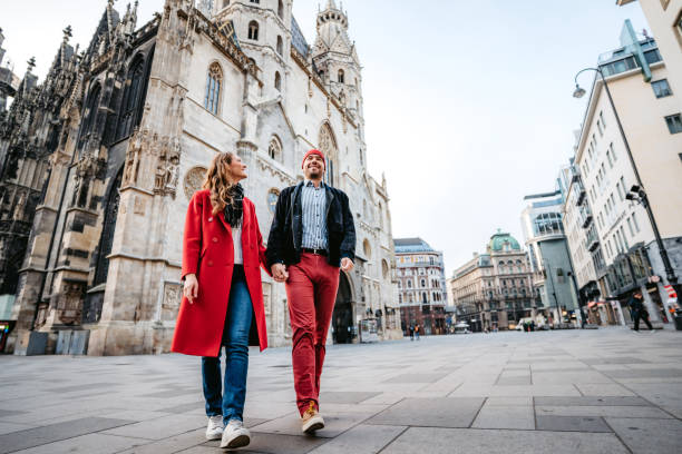 glückliches paar zu fuß die stadtstraße - wien österreich stock-fotos und bilder
