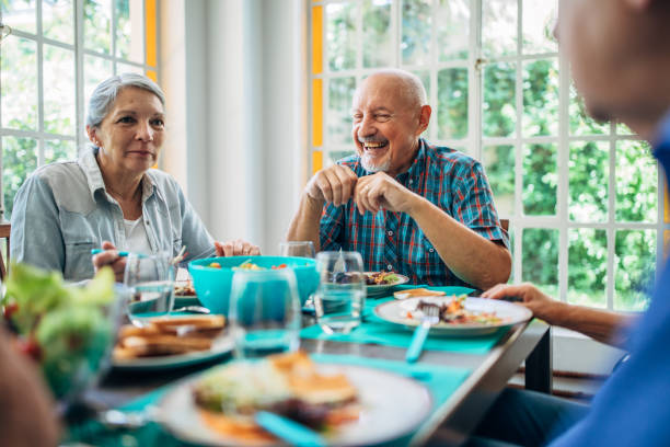 istock Seniors having meal in their retirement home 1196169431