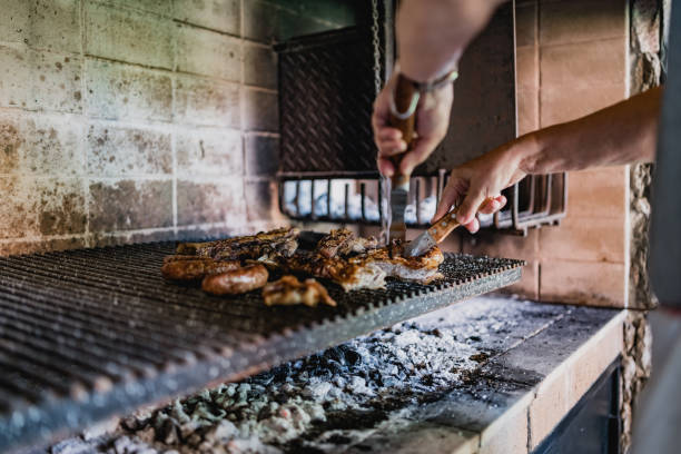 istock Senior man barbecue meat at home 1196170882