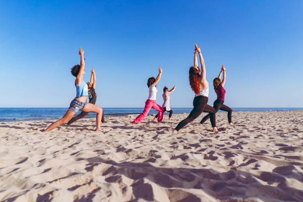 istock Group yoga on the beach 1196171582
