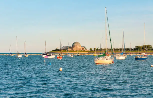 Landscape of lake Michigan with boats and Adler Planetarium in background, Chicago, Usa