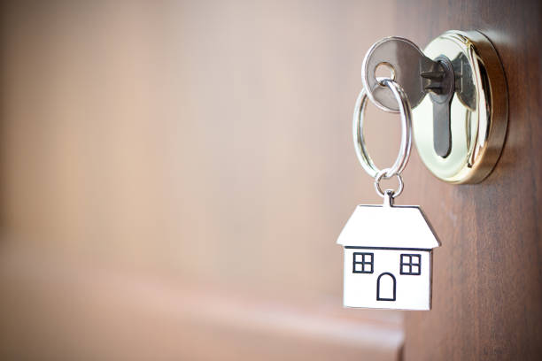 istock House key in the door. 1196172555