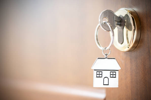 istock House key in the door. 1196172568