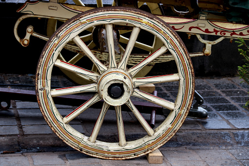 Old painted wooden gypsy caravan wheel at a country fair