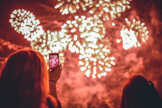 People watch Firework People watch and record fireworks firework display pyrotechnics celebration excitement stock pictures, royalty-free photos & images