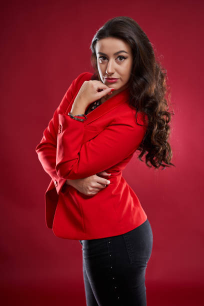 istock Young businesswoman on red background 1196176450