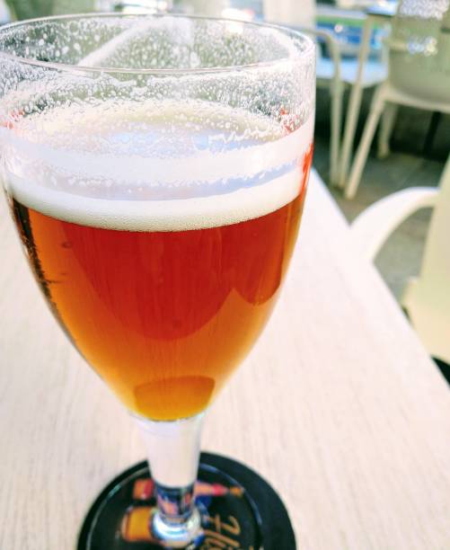 Glass of beer served on sidewalk cafe table, coaster, vacations in Galicia, Spain