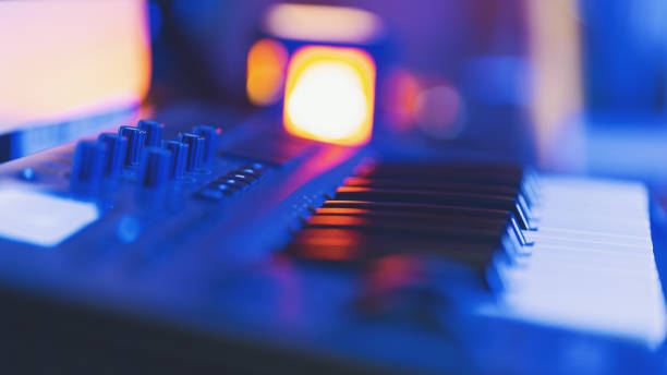 Midi keyboard in home studio in blue neon light Midi keyboard in home studio in blue neon light. Shallow depth of field home recording studio setup stock pictures, royalty-free photos & images