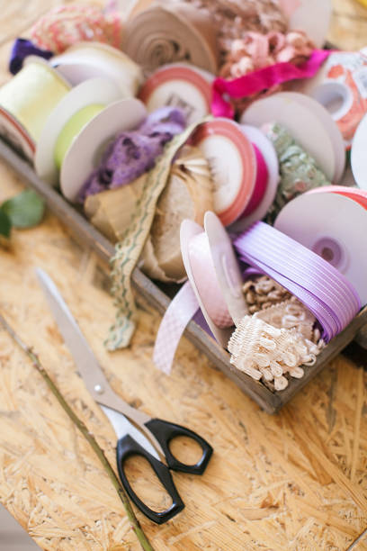 istock Ribbons and scissors. Learning how to create flower bouquets. Florist communication with customer in the workshop in the studio with flowers. 1196180056