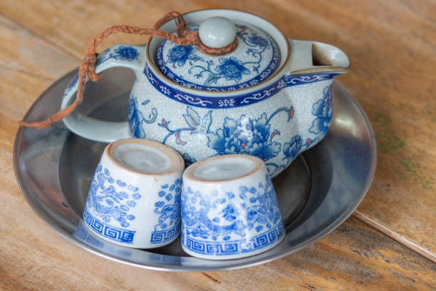 istock Chinese teapot and tea cups on wooden table 1196184944