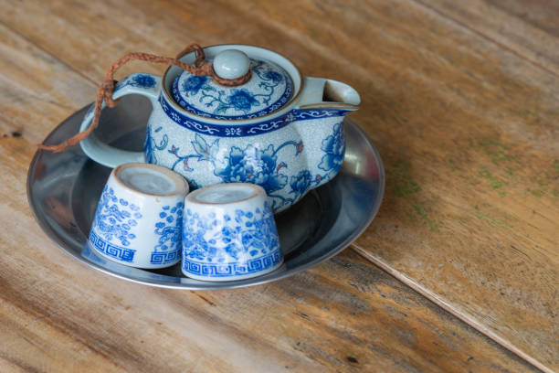 istock Chinese teapot and tea cups on wooden table 1196185077
