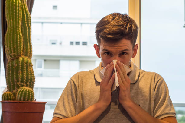 istock young man suffering from allergy at home 1196185273